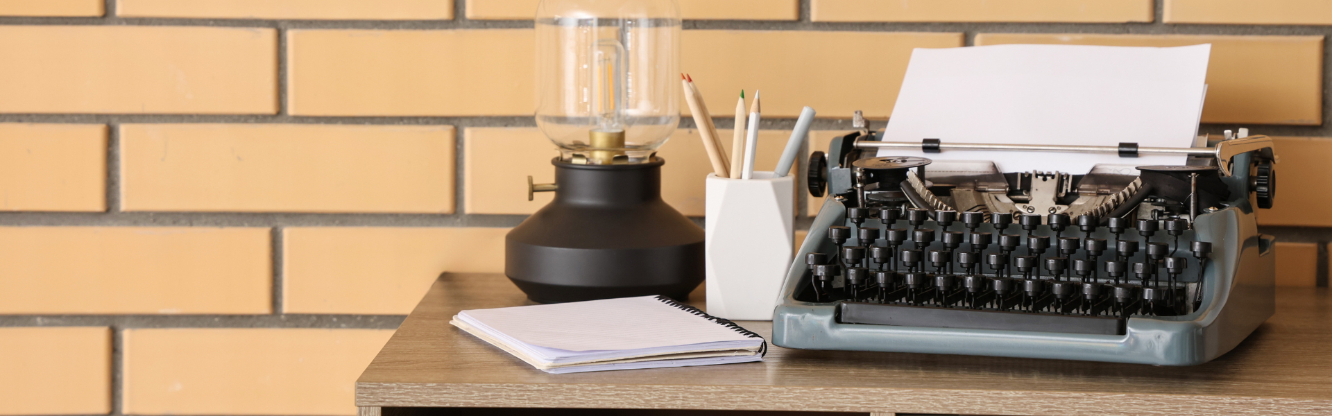 Photo of Typewriter and lamp on a desk
